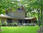 exterior view custom home in the woods michael Rust architect  Frank lloyd wright inspired custom home plans by former taliesin fellow